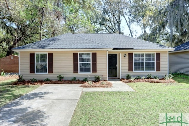 ranch-style house with a shingled roof and a front yard