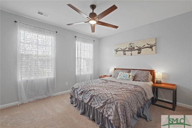 bedroom featuring carpet floors, visible vents, and baseboards