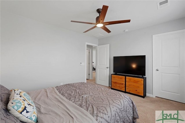 bedroom with light carpet, a ceiling fan, and visible vents