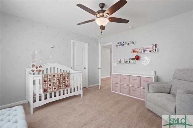 bedroom with light carpet, a ceiling fan, and baseboards