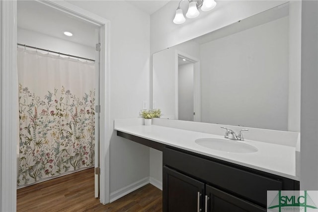 bathroom with baseboards, a shower with curtain, vanity, and wood finished floors