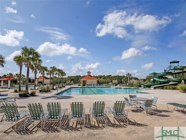 pool featuring a patio area and a water slide