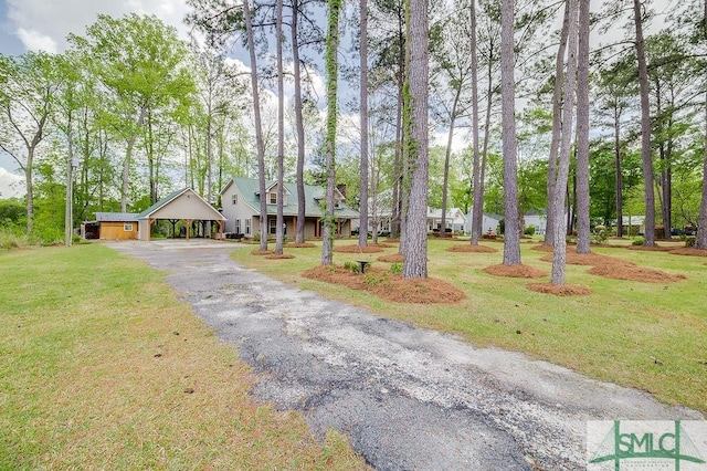 view of front of house with a front yard, driveway, and a carport