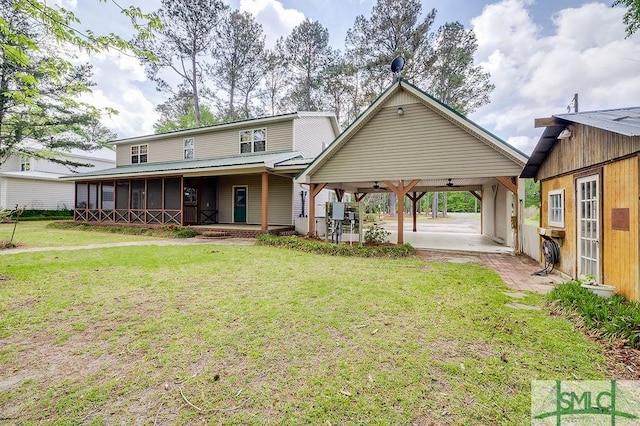back of property with a patio, an attached carport, ceiling fan, and a lawn