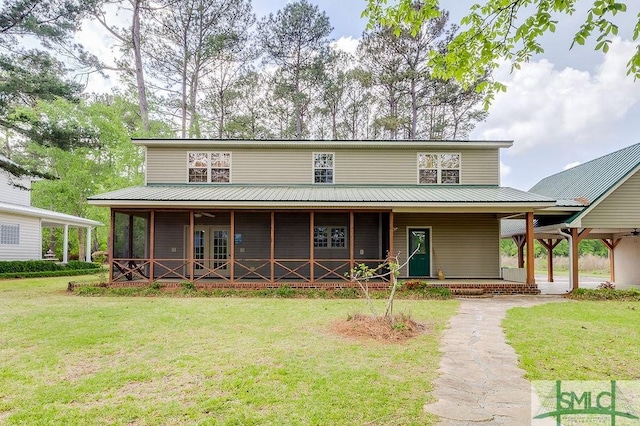 farmhouse with a front lawn, metal roof, and a porch
