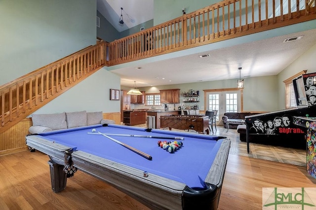 game room with billiards, light wood-style flooring, and french doors