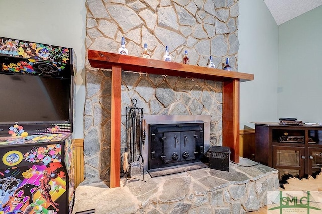 details featuring a textured ceiling and a stone fireplace