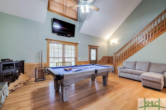 recreation room featuring wainscoting, wood finished floors, and a healthy amount of sunlight