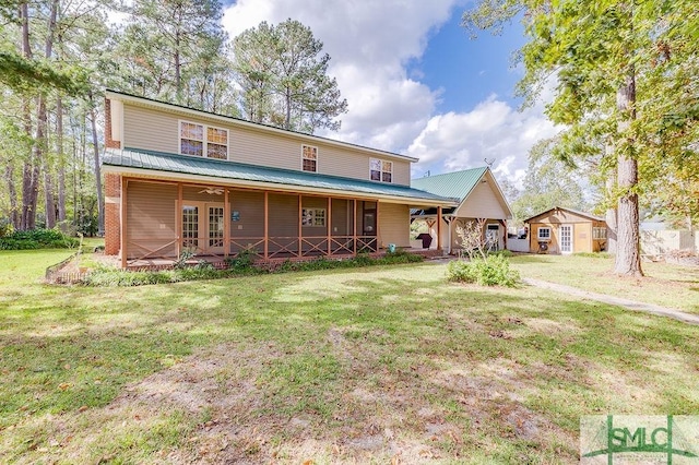 view of front facade featuring metal roof, a porch, and a front yard