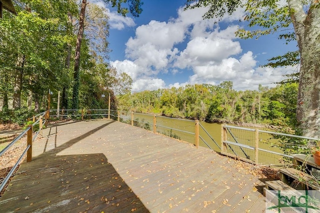 wooden deck featuring a view of trees