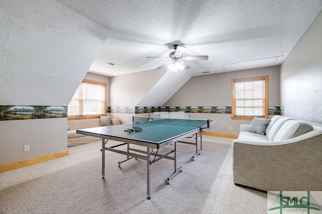 rec room featuring ceiling fan, visible vents, attic access, and light colored carpet
