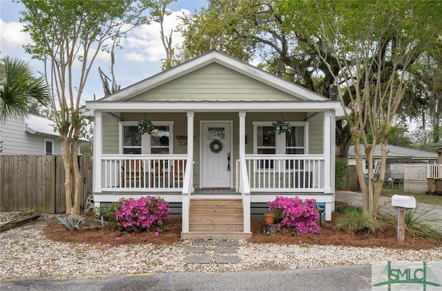 3223 Cedar St, Savannah, GA 31404 - shotgun-style home with covered porch and fence