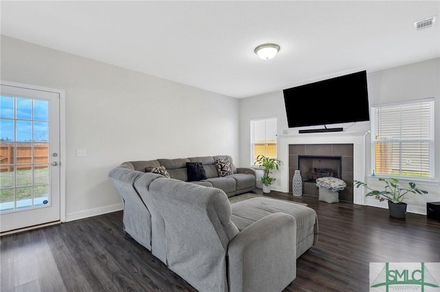 31 Fridley Ln, Hinesville, GA 31313 - living area featuring a tiled fireplace, baseboards, dark wood finished floors, and visible vents
