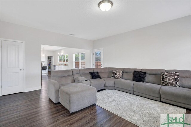 31 Fridley Ln, Hinesville, GA 31313 - living room featuring dark wood-style flooring, visible vents, baseboards, and a notable chandelier