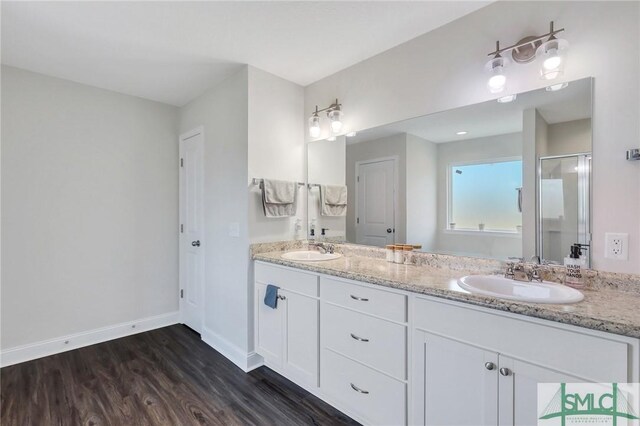 31 Fridley Ln, Hinesville, GA 31313 - bathroom featuring a sink, a shower stall, double vanity, and wood finished floors