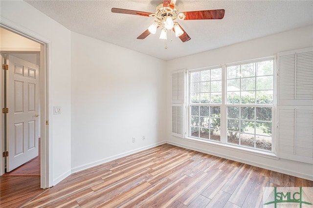 28 Raven Wood Way, Pooler, GA 31322 - spare room featuring light wood-type flooring, ceiling fan, a textured ceiling, and a wealth of natural light