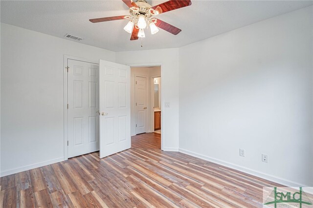 28 Raven Wood Way, Pooler, GA 31322 - unfurnished bedroom with light wood finished floors, baseboards, a ceiling fan, and visible vents