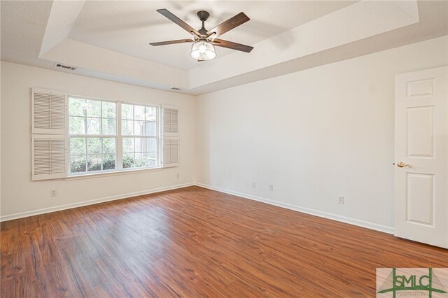 28 Raven Wood Way, Pooler, GA 31322 - empty room with a tray ceiling, a ceiling fan, visible vents, wood finished floors, and baseboards