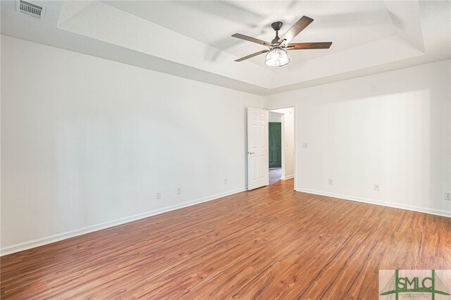 28 Raven Wood Way, Pooler, GA 31322 - empty room with baseboards, a raised ceiling, visible vents, ceiling fan, and wood finished floors