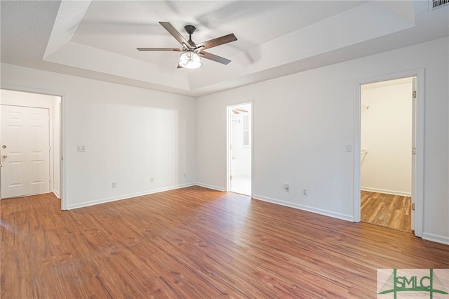 28 Raven Wood Way, Pooler, GA 31322 - unfurnished room with baseboards, wood finished floors, a ceiling fan, and a raised ceiling