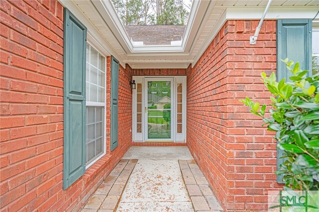 28 Raven Wood Way, Pooler, GA 31322 - view of exterior entry featuring a shingled roof and brick siding