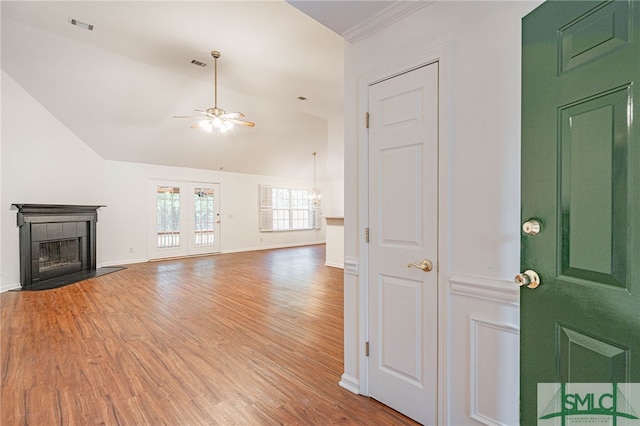 28 Raven Wood Way, Pooler, GA 31322 - unfurnished living room featuring visible vents, a tiled fireplace, a ceiling fan, vaulted ceiling, and light wood-style flooring