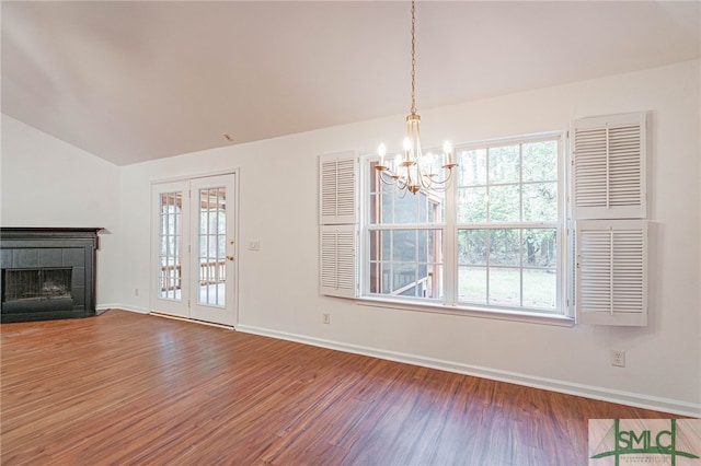 28 Raven Wood Way, Pooler, GA 31322 - unfurnished living room featuring wood finished floors, an inviting chandelier, a tiled fireplace, and vaulted ceiling