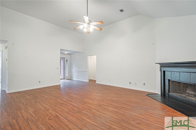 28 Raven Wood Way, Pooler, GA 31322 - unfurnished living room with high vaulted ceiling, a fireplace, a ceiling fan, and wood finished floors