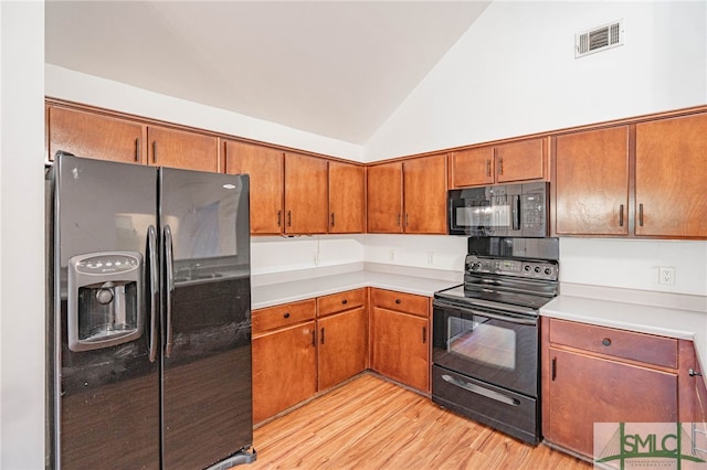 28 Raven Wood Way, Pooler, GA 31322 - kitchen with visible vents, brown cabinetry, black appliances, and lofted ceiling