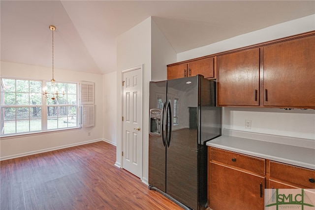 28 Raven Wood Way, Pooler, GA 31322 - kitchen featuring light wood-style floors, brown cabinetry, vaulted ceiling, black fridge, and a chandelier