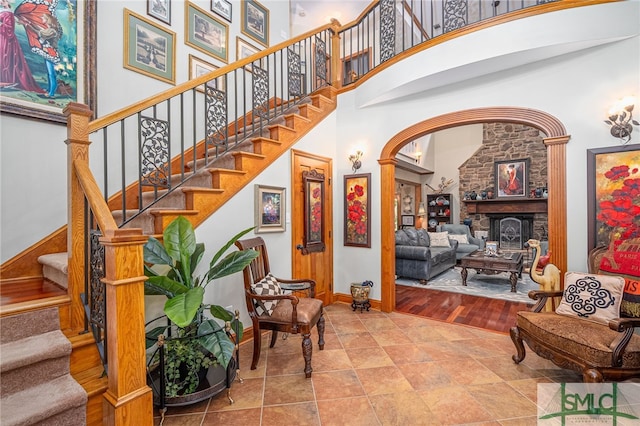 57 Delegal Rd, Savannah, GA 31411 - staircase featuring arched walkways, a towering ceiling, and baseboards