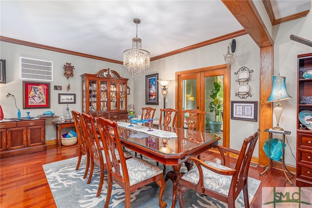 57 Delegal Rd, Savannah, GA 31411 - dining space with a chandelier, crown molding, wood finished floors, and baseboards