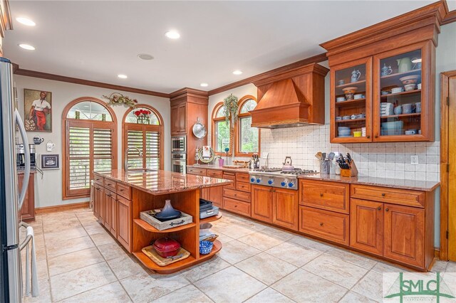 57 Delegal Rd, Savannah, GA 31411 - kitchen with custom range hood, backsplash, open shelves, light stone countertops, and stainless steel appliances
