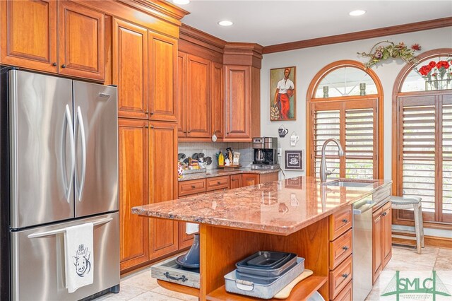 57 Delegal Rd, Savannah, GA 31411 - kitchen featuring a sink, brown cabinetry, appliances with stainless steel finishes, and light stone counters