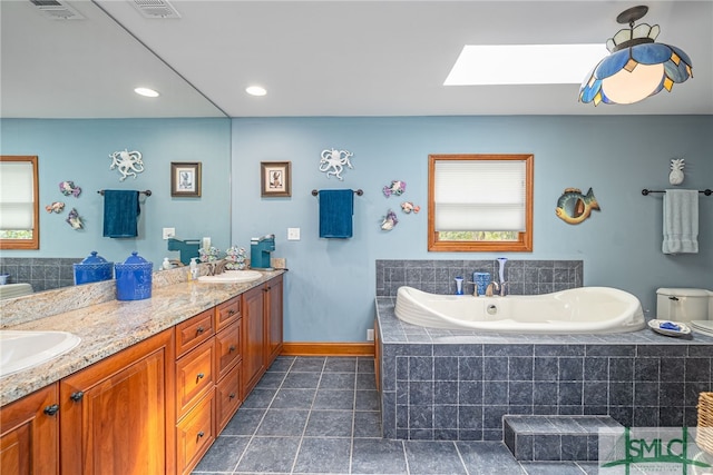 57 Delegal Rd, Savannah, GA 31411 - full bath with a sink, visible vents, a skylight, and a garden tub