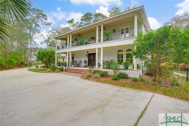 57 Delegal Rd, Savannah, GA 31411 - view of front of property featuring concrete driveway, a porch, ceiling fan, and a balcony
