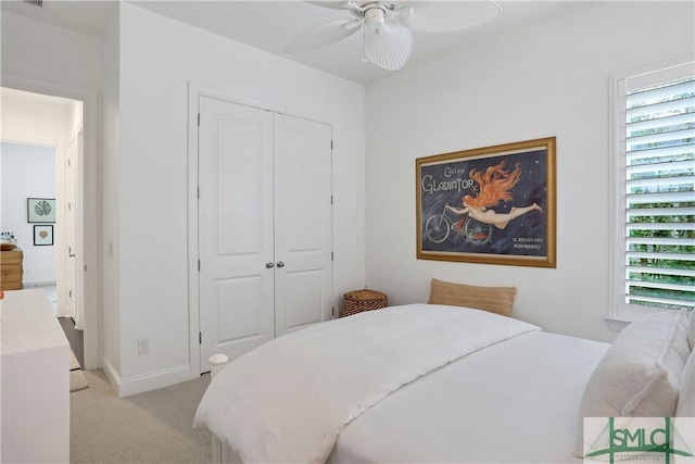 bedroom with a closet, visible vents, baseboards, ceiling fan, and light colored carpet