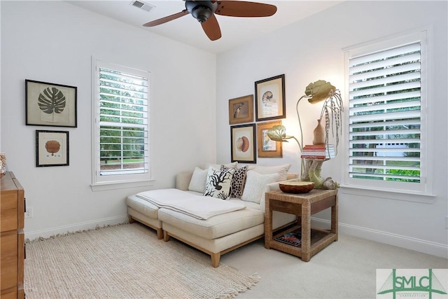 sitting room featuring visible vents, ceiling fan, baseboards, and carpet
