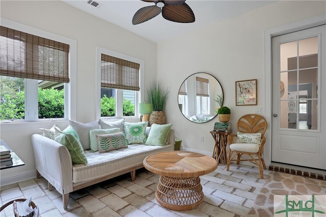 sitting room with baseboards and a ceiling fan
