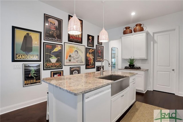 kitchen with a sink, white cabinets, white dishwasher, and dark wood-type flooring
