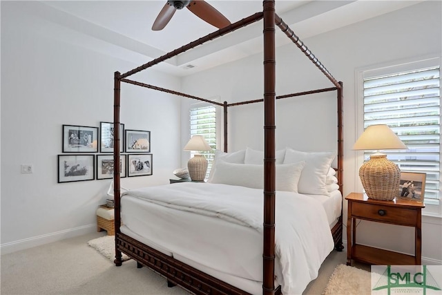 carpeted bedroom featuring visible vents, baseboards, and a ceiling fan