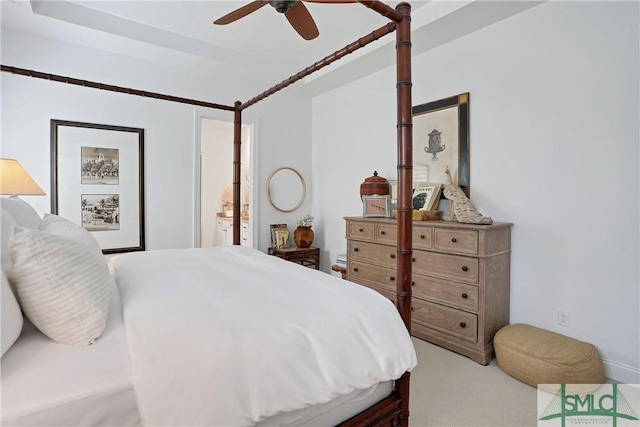 bedroom with ensuite bathroom, ceiling fan, and carpet floors