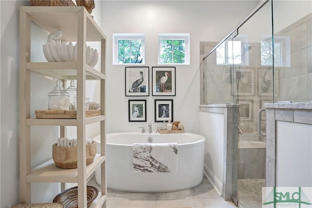 full bathroom with a stall shower and a freestanding bath