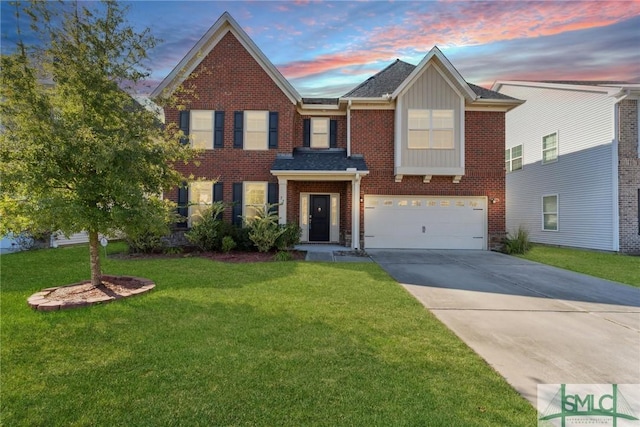traditional-style house featuring brick siding, a garage, a yard, and driveway