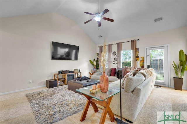 carpeted living area featuring high vaulted ceiling, visible vents, baseboards, and ceiling fan