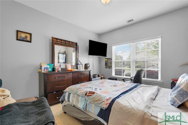 bedroom with light carpet and visible vents