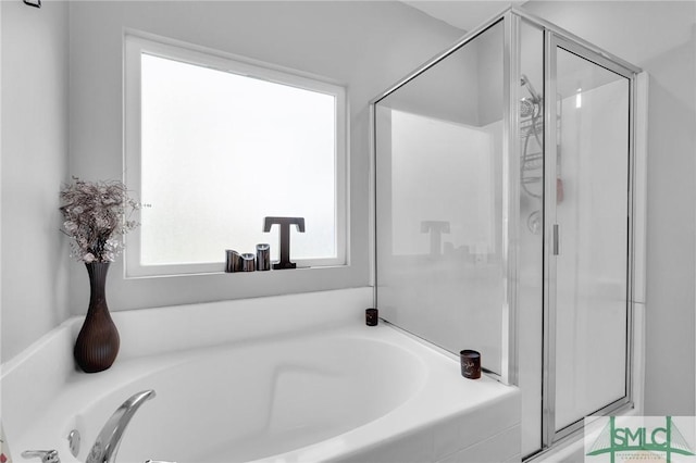 full bath with a bath and a stall shower