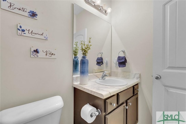 bathroom with toilet and vanity