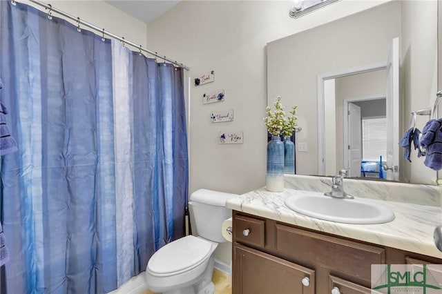 bathroom with toilet, curtained shower, and vanity