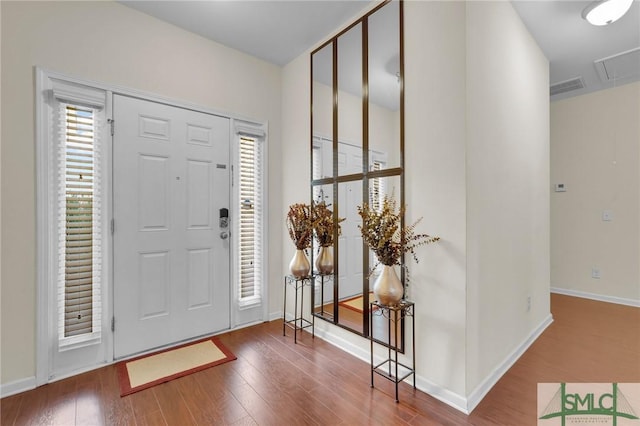 entrance foyer with visible vents, baseboards, and wood finished floors